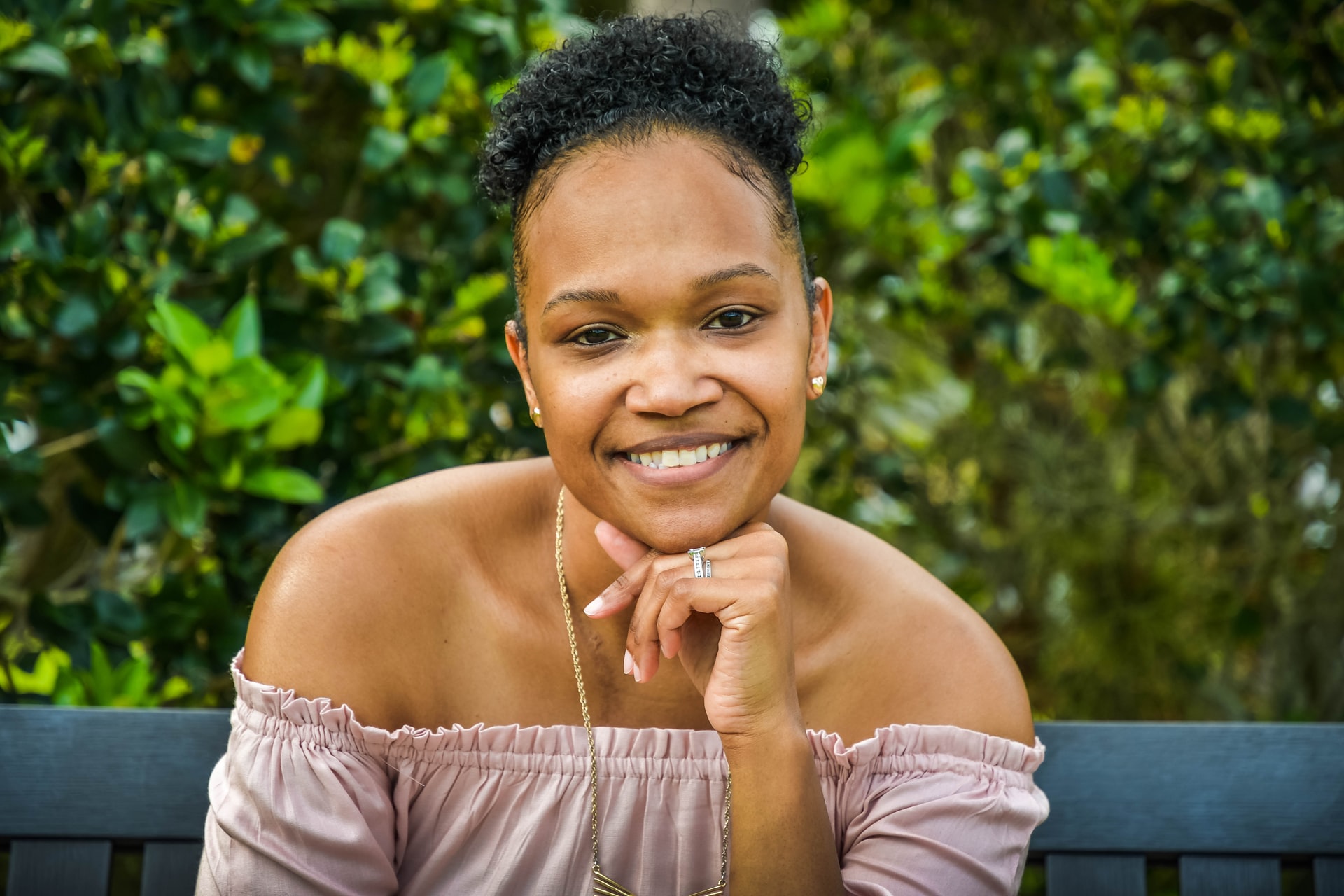 Smiling woman outdoors, illustrating wellbeing and hope
